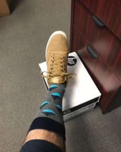 gray and blue Transparensa Fuels socks in office