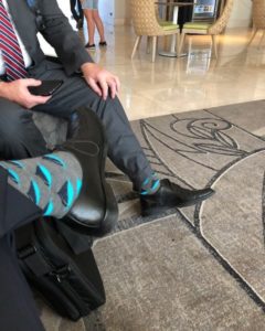 People in suits showing off gray Transparensa Fuels socks